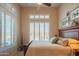 Cozy bedroom with plantation shutters offers scenic views from the comfort of home at 40607 N Candlewyck Ln, Phoenix, AZ 85086