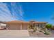 Southwestern home with desert landscaping, three-car garage, and neutral stucco and stone exterior at 40607 N Candlewyck Ln, Phoenix, AZ 85086