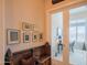 Hallway with art and an antique wooden bench, leading to a room with a full-light glass door at 40607 N Candlewyck Ln, Phoenix, AZ 85086