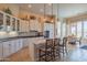 A spacious kitchen boasts white cabinets, sleek countertops, pendant lights, and an adjacent breakfast nook at 40607 N Candlewyck Ln, Phoenix, AZ 85086