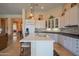 Bright kitchen featuring white cabinets, stainless steel appliances, and an island with seating at 40607 N Candlewyck Ln, Phoenix, AZ 85086