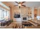 Spacious living room featuring a stone fireplace, built-in shelving, and views of the backyard at 40607 N Candlewyck Ln, Phoenix, AZ 85086