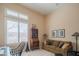 Bright office with a sofa, cabinet, desk, and decorative pieces, illuminated by window light at 40607 N Candlewyck Ln, Phoenix, AZ 85086