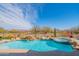 Backyard pool with waterfall feature and jacuzzi offers a tranquil outdoor space with desert views at 40607 N Candlewyck Ln, Phoenix, AZ 85086