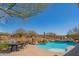 Backyard pool with waterfall, spa, and desert view, providing a serene outdoor retreat and dining area at 40607 N Candlewyck Ln, Phoenix, AZ 85086