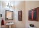 Chic powder room featuring decorative mirror and a pedestal sink at 40607 N Candlewyck Ln, Phoenix, AZ 85086