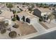 Aerial view of a property with a two-car garage, desert landscaping, and easy street access at 43556 W Colby Dr, Maricopa, AZ 85138