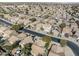 Aerial view of community, showing rooflines, landscaping, and street layout, located in a residential neighborhood at 43556 W Colby Dr, Maricopa, AZ 85138