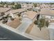 Aerial view of a home featuring desert landscaping, a two-car garage, and a well-maintained front yard at 43556 W Colby Dr, Maricopa, AZ 85138