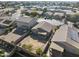 Aerial view of homes, highlighting a backyard with a fire pit and other community features at 43556 W Colby Dr, Maricopa, AZ 85138