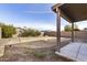 Spacious backyard featuring a covered patio and low-maintenance landscaping, ready for your personal touch at 43556 W Colby Dr, Maricopa, AZ 85138