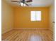 Bright bedroom with neutral walls, wood floors, and a ceiling fan at 43573 W Blazen Trl, Maricopa, AZ 85138