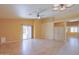 Bright living room featuring wood floors, ceiling fan and sliding glass doors to the backyard at 43573 W Blazen Trl, Maricopa, AZ 85138