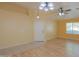 Inviting living room with wood floors, ceiling fan and adjacent dining area at 43573 W Blazen Trl, Maricopa, AZ 85138