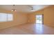 Spacious living room with wood floors, a ceiling fan and lots of natural light at 43573 W Blazen Trl, Maricopa, AZ 85138