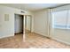 Bedroom featuring tile flooring, neutral paint, closet with mirrored doors and a window for natural light at 4630 N 68Th St # 253, Scottsdale, AZ 85251