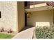 Inviting condo entrance with number 253, featuring a walkway, garden bed, and balcony above at 4630 N 68Th St # 253, Scottsdale, AZ 85251