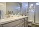 Bright bathroom features a glass-door shower and a neutral-toned vanity with a light countertop at 4750 S Rhodium Ln, Mesa, AZ 85212