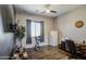 Versatile room with wood floors provides space for a home office or fitness equipment and a wall-mounted TV at 4750 S Rhodium Ln, Mesa, AZ 85212