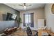 This versatile room with wood floors provides space for a home office or fitness equipment and a wall-mounted TV at 4750 S Rhodium Ln, Mesa, AZ 85212