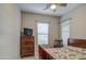 Cozy bedroom featuring neutral walls, a dresser, and a window with natural light at 4750 S Rhodium Ln, Mesa, AZ 85212