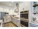 Bright kitchen features stainless steel appliances, white cabinets, subway tile backsplash, and granite countertops at 4750 S Rhodium Ln, Mesa, AZ 85212