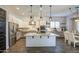 Bright kitchen boasts an island, stainless appliances, and stylish pendant lighting at 4750 S Rhodium Ln, Mesa, AZ 85212