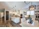 Open-concept kitchen features white cabinets, an island, and stainless steel appliances at 4750 S Rhodium Ln, Mesa, AZ 85212