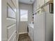 Well-organized laundry room with washer, dryer, cabinets, shelves, and natural light at 4750 S Rhodium Ln, Mesa, AZ 85212