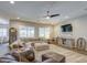 Expansive living room with modern decor, large sectional, ceiling fan and plantation shutters at 4750 S Rhodium Ln, Mesa, AZ 85212