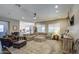 Open-concept living room with modern decor, large sectional, ceiling fan and plantation shutters at 4750 S Rhodium Ln, Mesa, AZ 85212