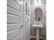 Charming powder room with pedestal sink, decorative mirror, and coastal-themed accents at 4750 S Rhodium Ln, Mesa, AZ 85212