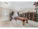 Carpeted game room with a pool table, shelving, and white walls at 5043 W Christy Dr, Glendale, AZ 85304