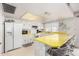 Bright kitchen with white cabinets, yellow countertops, and bar seating at 5043 W Christy Dr, Glendale, AZ 85304