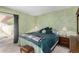 This main bedroom features a bed, dresser, and sliding glass door for natural light at 5043 W Christy Dr, Glendale, AZ 85304