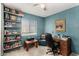 Office with light blue walls, desk, chair, and shelving at 5043 W Christy Dr, Glendale, AZ 85304