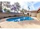 Inviting backyard featuring a private pool surrounded by mature trees, a spacious patio, and a block wall for added privacy at 5043 W Christy Dr, Glendale, AZ 85304