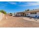 Spacious backyard featuring a covered patio, convenient storage shed, and stylish circular brickwork at 5256 W Port Au Prince Ln, Glendale, AZ 85306