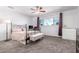 Inviting bedroom with a large window, neutral carpet, and a ceiling fan at 5256 W Port Au Prince Ln, Glendale, AZ 85306