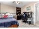 Bedroom features a workspace with shelves, a ceiling fan, and neutral paint at 5256 W Port Au Prince Ln, Glendale, AZ 85306