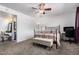 Inviting bedroom with a large window, neutral carpet, and a ceiling fan at 5256 W Port Au Prince Ln, Glendale, AZ 85306