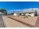 Inviting single-story home with desert landscaping and a two-car garage on a corner lot at 5256 W Port Au Prince Ln, Glendale, AZ 85306