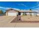 Charming single-story home with a well-maintained front yard and attached two-car garage at 5256 W Port Au Prince Ln, Glendale, AZ 85306