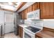 Charming kitchen with stainless steel appliances, wood cabinets, and a bright, airy feel at 5256 W Port Au Prince Ln, Glendale, AZ 85306