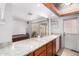 Stylish kitchen with a white sink, stone countertop, and a view of a pool table at 5256 W Port Au Prince Ln, Glendale, AZ 85306