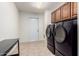 A spacious laundry room is equipped with a modern washer and dryer set at 5256 W Port Au Prince Ln, Glendale, AZ 85306