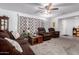 Inviting living room featuring comfortable seating, a ceiling fan, and a view into other spaces at 5256 W Port Au Prince Ln, Glendale, AZ 85306