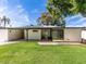 A home's backyard featuring a well-maintained lawn and covered patio area at 5807 N 18Th St, Phoenix, AZ 85016