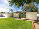 A view of the backyard featuring lush green grass and the home's rear exterior at 5807 N 18Th St, Phoenix, AZ 85016