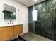 Modern bathroom featuring green tiled shower, sleek vanity, and contemporary fixtures at 5807 N 18Th St, Phoenix, AZ 85016